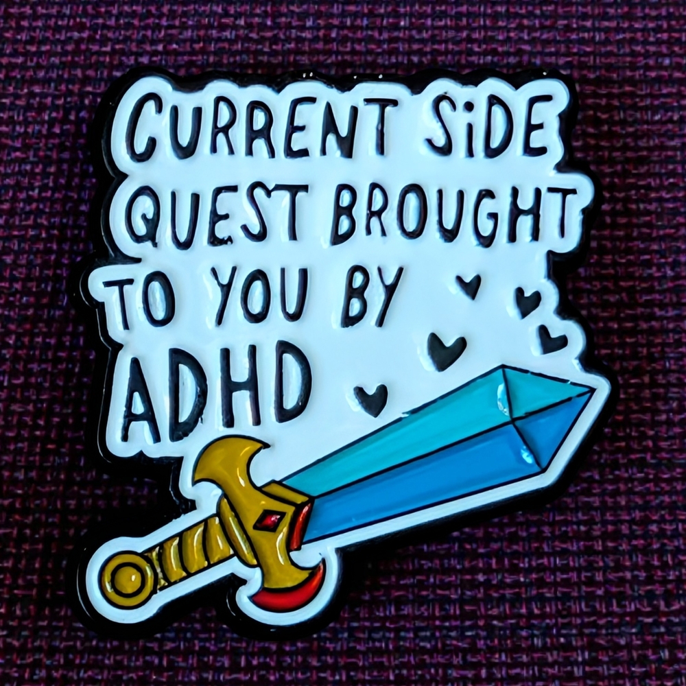 "Current Side Quest Brought To You By ADHD" Enamel Pin with Blue Crystal Sword